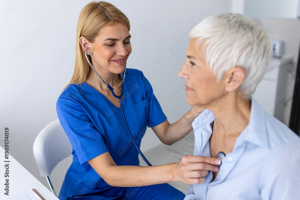 Fototapeta premium Close Up of Female Doctor Using Stethoscope on Senior Patient, Professional Medical Healthcare Auscultation for Elderly Woman, Clinical Diagnostic Screening and Preventive Patient Care in Clinic.