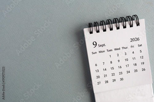 Desk calendar for September 2026 on an orange background.
