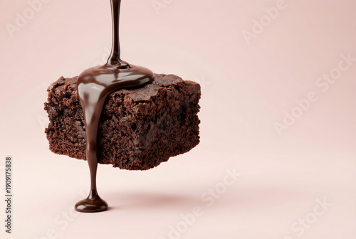 Liquid Chocolate Pouring Over Fudgy Brownie On Pink Background
