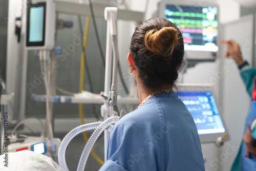 Healthcare provider monitoring patient vital signs in critical care