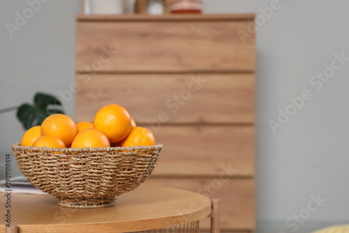 Wicker bowl with oranges on...