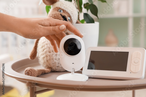 Woman with baby monitor and...