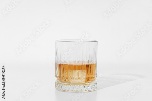 Glass of rum with ice cube ...