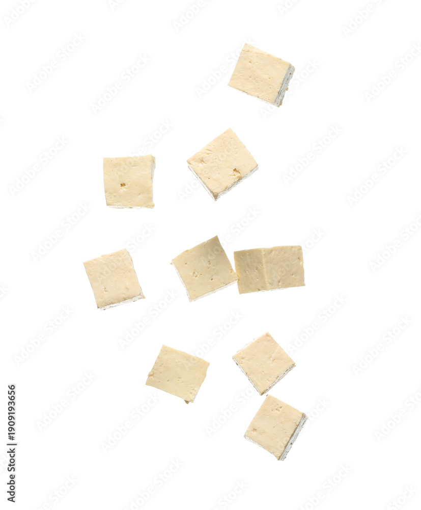 Obraz premium Pieces of flying tasty tofu cheese isolated on white background