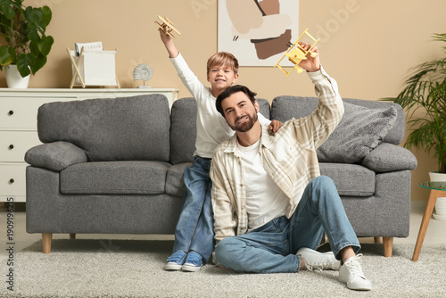 Man and his little son play...