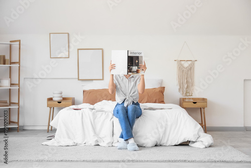 Young woman reading interio...