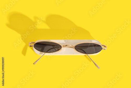 Stylish sunglasses and plas...