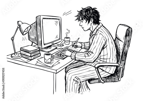 Young man in pajamas works from home at his computer desk, writing and typing, ideal for concepts of remote work, study, or latenight productivity.