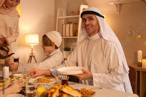 Young Muslim man having fam...