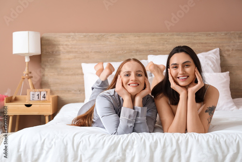 Young lesbian couple in bed...