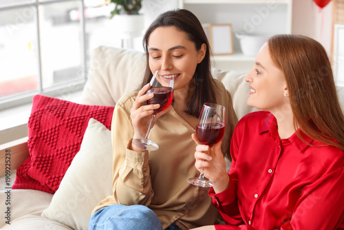 Young lesbian couple drinki...