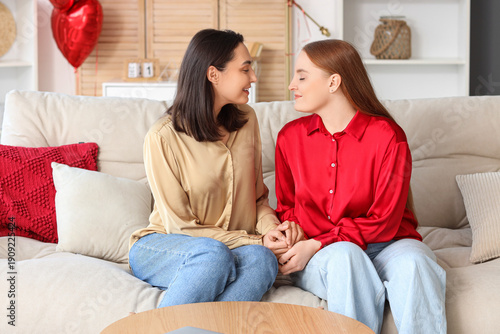 Young lesbian couple sittin...