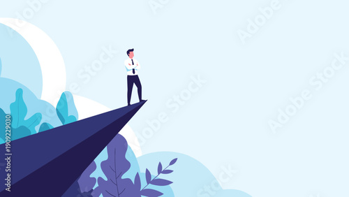 Courageous businessman standing on the edge of a high mountain cliff looking out into the distance towards future opportunities.
