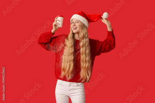 Young woman in Santa hat wi...