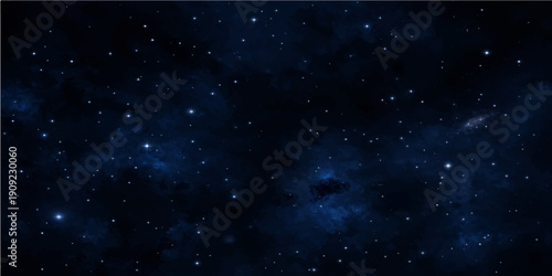 A cosmic night sky starfield features a dark universe filled with a glowing blue nebula and starry light across the vast outer space galaxy
