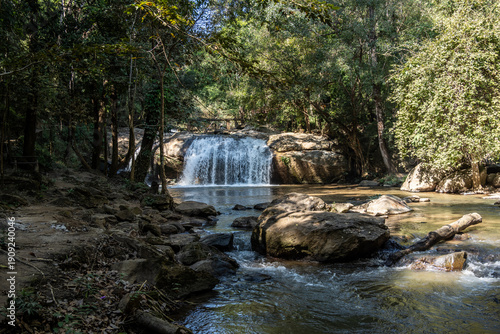 A waterfall in a mountain forest in Thailand on a sunny day