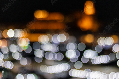 Blurred night scene with white and orange bokeh lights against a dark background. Jamaa el Fna,Marrakech,Unesco hertage,Morocco