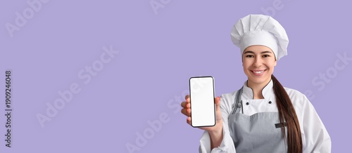 Young female chef with mobi...