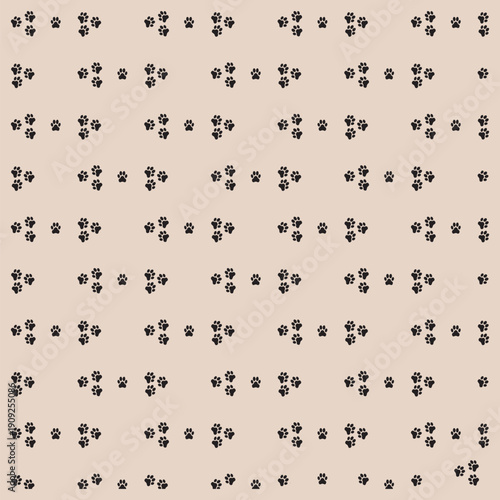 Abstract pattern of scattered dark brown paws, foot print on a light beige background creating a minimalist repeating texture