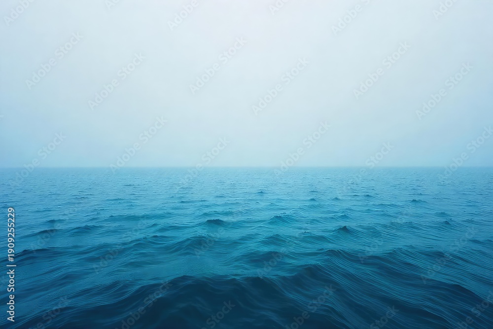Obraz premium Vast, endless ocean meeting the hazy horizon, a tranquil scene of blue and grey under a calm sky Perfect for travel, nature, and serenity themes , wide, beautiful, tranquil