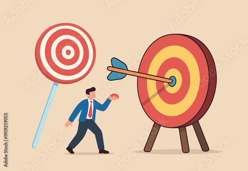 Aiming for children education target, parenting or kid knowledge or skill, humor business target or achievement concept, bow arrow children toy with suction cup hit sweet lollypop bullseye target.