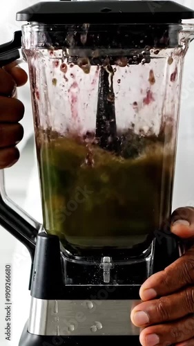 Making a Healthy Green Smoothie with Fresh Fruits and Spinach in a Blender.
