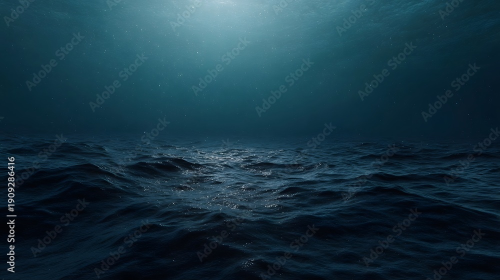 Obraz premium Serene underwater view of the ocean surface with sunlight filtering through dark blue water and gentle waves