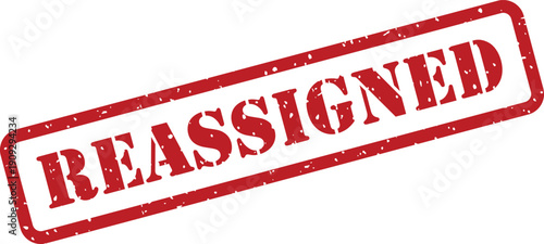 Red rubber stamp prominently displaying the word Reassigned for official status change documentation