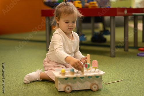 child girl  plays with a toys in kindergarten lifestyle