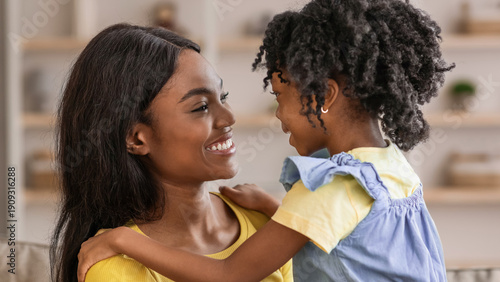 Tableau sur toile A mother and daughter share a joyful moment in their home