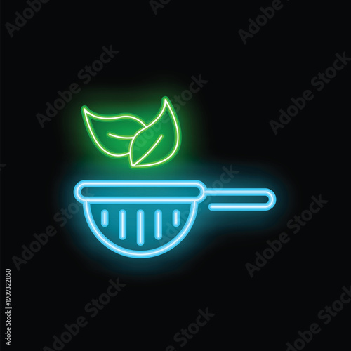 Neon icon of green tea leaves floating over a blue tea strainer on a black background