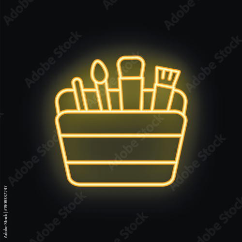 Neon sign of a make up brush set in a box shining brightly on a black wall