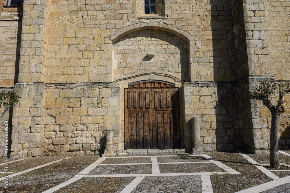 Fototapeta premium Entrance of San Miguel Church in Pina de Campos Palencia with dome and wooden doors