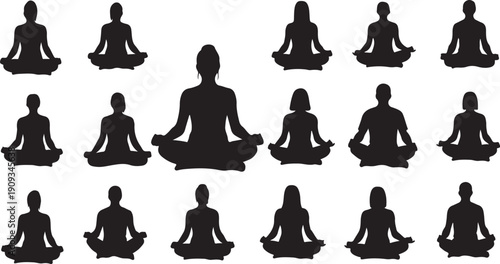 Silhouettes of people meditating in yoga poses together peacefully