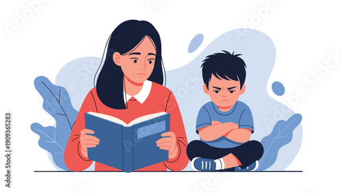 Concerned mother reading a book while her young son sits next to her with a grumpy expression and crossed arms at home.