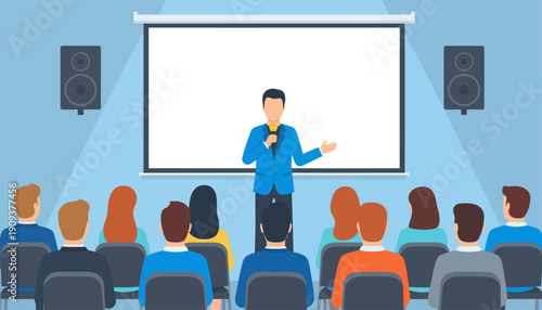 A man presents on stage to an audience seated in front of a projector screen.