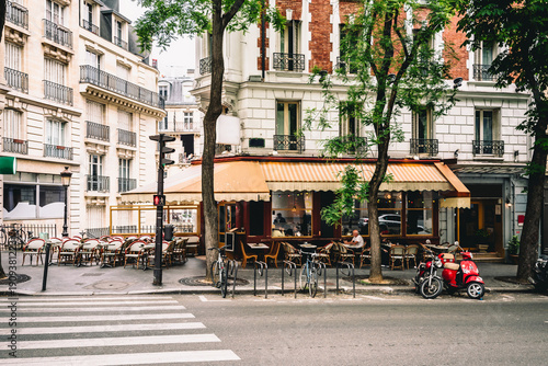 Bild auf Leinwand Cozy street with tables of cafe in quarter Montmartre in Paris, France