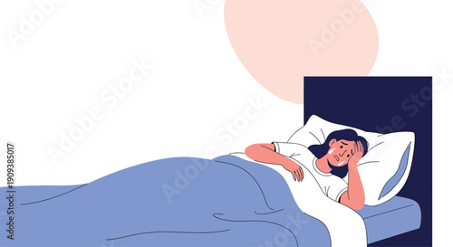 Distressed woman lying in bed at night crying and feeling overwhelmed with sadness while covered by a large blue blanket coverlet.