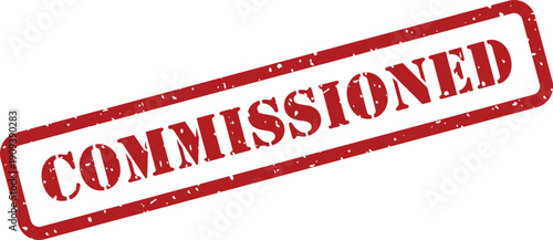 Red rubber stamp with the word COMMISSIONED in a rectangular frame on a clear white surface