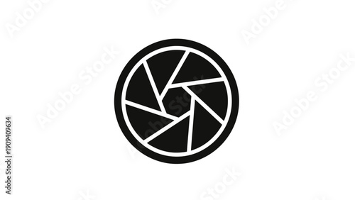 Black and white circular graphic. It has a series of geometric shapes, resembling a camera lens aperture