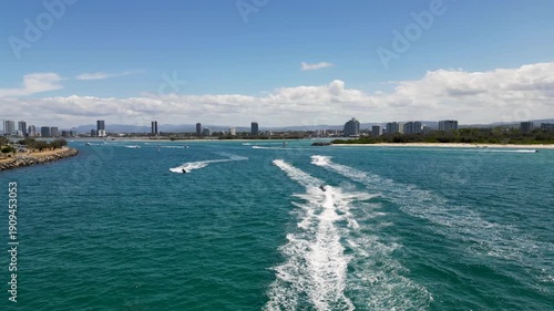 Aerial drone video following jetskis at the spit, Gold Coast