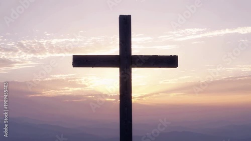 Wooden Cross Stands Silhouetted Against Soft Pastel Sunset Sky