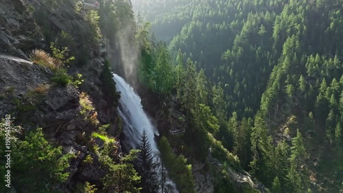 Drone view of Stuibenfall waterfall surrounded by alpine mountains and pine forests highlighting pristine nature landscapes and popular tourism in Austria