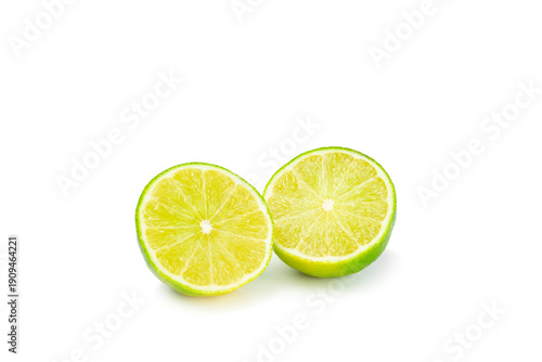 Fresh lime isolated on white background. Whole limes and slices in a bowl. Citrus. Vitamin C. Detox diet. Tropical fruits. Summer refreshing lemonade or mojito concept.