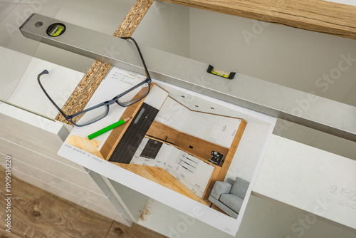 Designing new kitchen furniture, glasses, pencil, and ruler on a drawing board, designer designs built-in units,