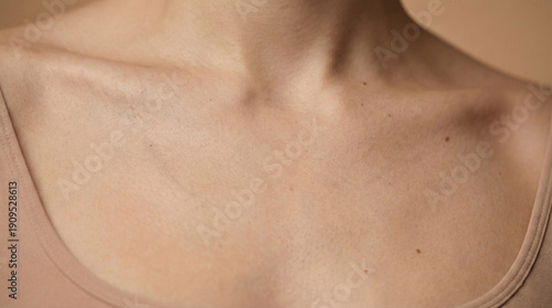Wallpaper Mural Aesthetic close-up of a woman's neck and collarbone area with natural skin texture and freckles on beige background Torontodigital.ca