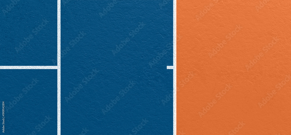 Fototapeta premium Top view tennis court surface detail with blue and orange playing areas, clean white line markings