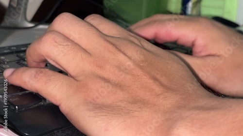 Close up of male hands typing on black computer keyboard for programming office work or digital business communication concept