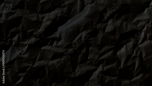 Crumpled black paper texture background closeup