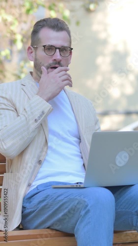 Shocked Modern Casual Man Looking at Camera while Sititng Outdoor, Vertical Video
